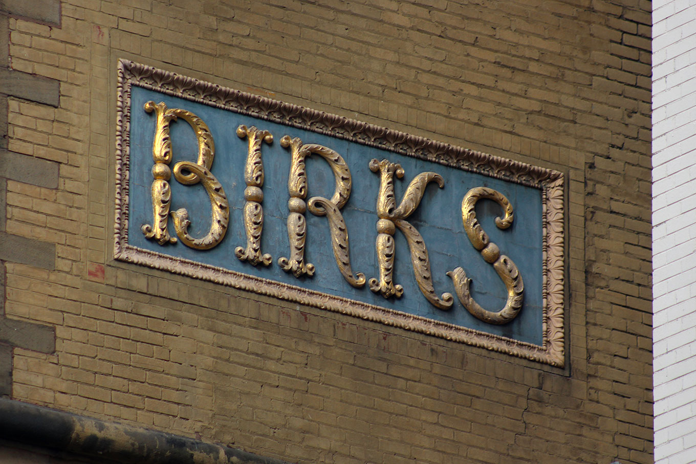 Enormous expressive letters on the side of the Birks Building on Phillips Square.